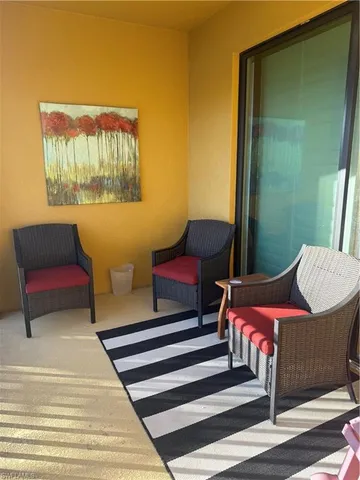 a balcony with a table and chairs