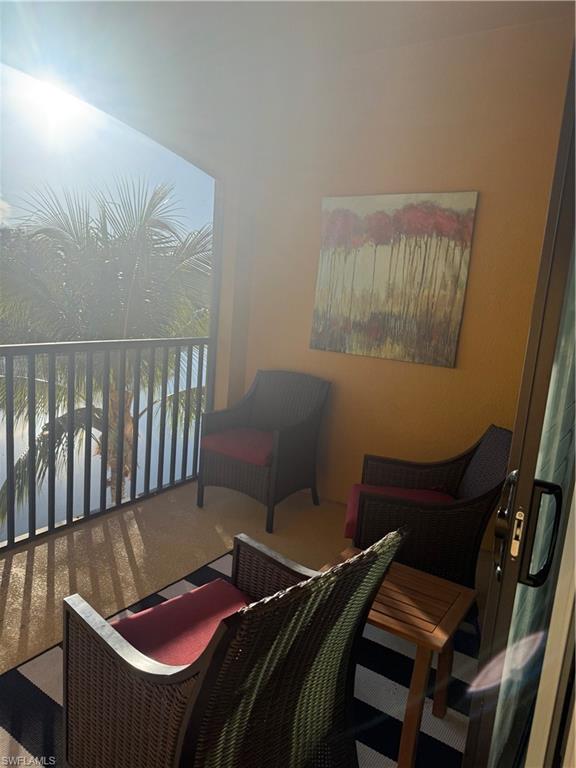 9566 Trevi Court, Unit 4935 Naples, FL 34113 - Photo 18 of 20 a balcony with a table and chairs