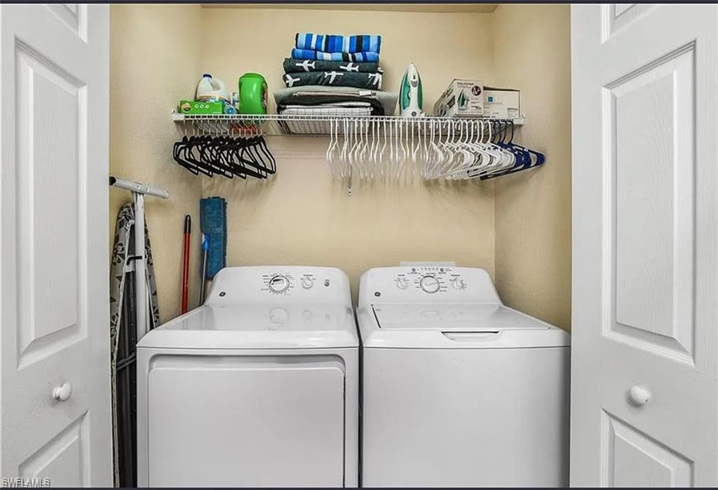 9566 Trevi Court, Unit 4935 Naples, FL 34113 - Photo 6 of 20 a utility room with dryer and washer