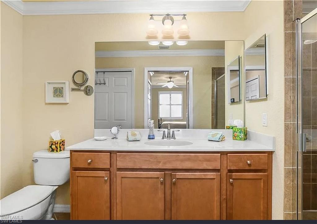 9566 Trevi Court, Unit 4935 Naples, FL 34113 - Photo 10 of 20 a bathroom with a granite countertop sink mirror and toilet