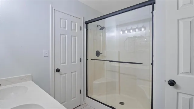 a bathroom with a shower and a sink