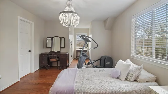 a bed room with a bed and a chandelier