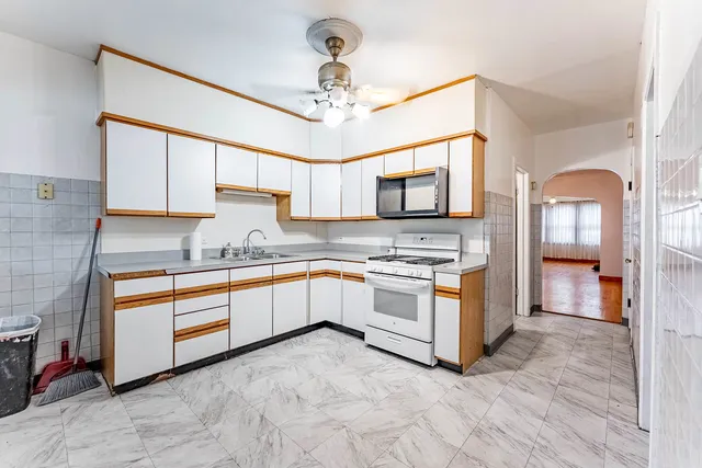 a kitchen with stainless steel appliances granite countertop a stove sink and cabinets