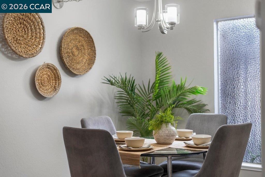 5468 Roundtree Drive, Unit C Concord, CA 94521 - Photo 11 of 27 a dining room with furniture and wooden floor