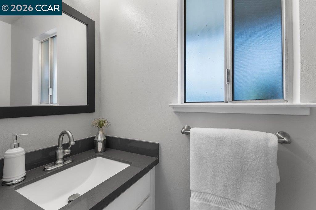 5468 Roundtree Drive, Unit C Concord, CA 94521 - Photo 17 of 27 a bathroom with a sink and a mirror