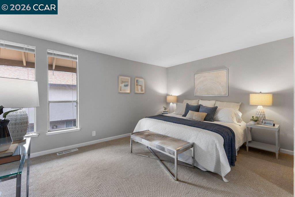 5468 Roundtree Drive, Unit C Concord, CA 94521 - Photo 18 of 27 a bedroom with a bed and a window