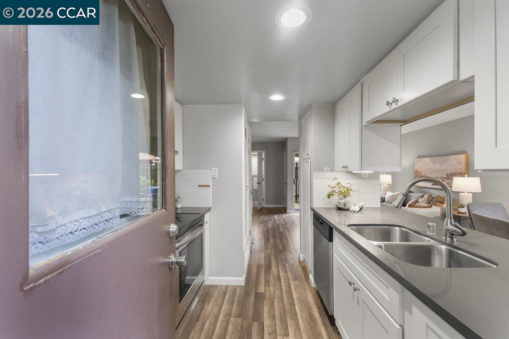 5468 Roundtree Drive, Unit C Concord, CA 94521 - Photo 2 of 27 a kitchen with stainless steel appliances granite countertop a sink and a refrigerator