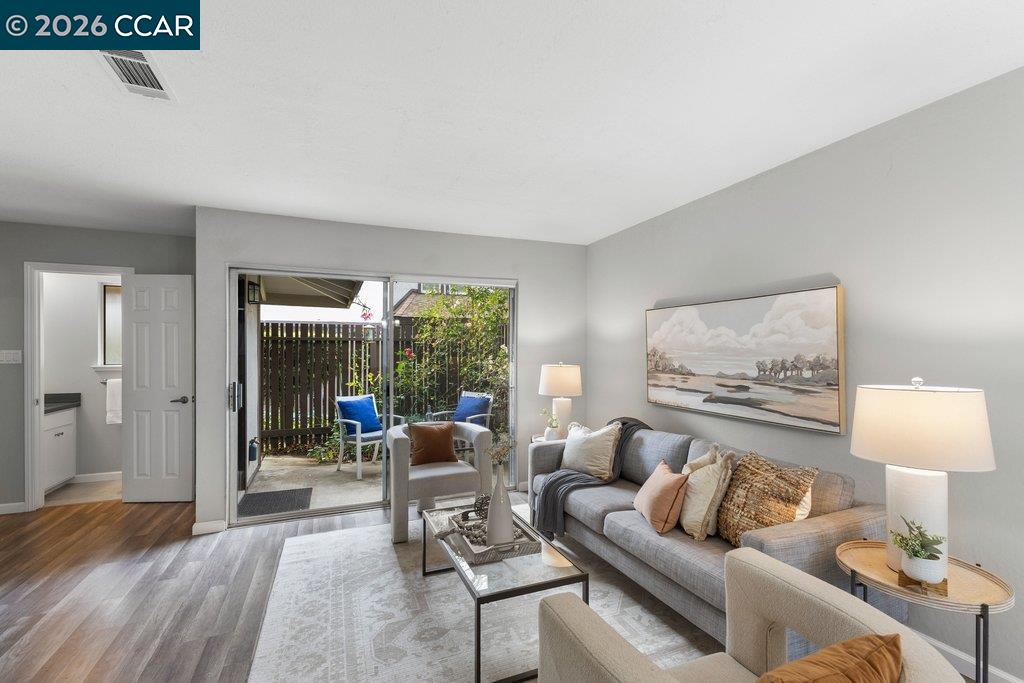 5468 Roundtree Drive, Unit C Concord, CA 94521 - Photo 3 of 27 a living room with furniture and a lamp