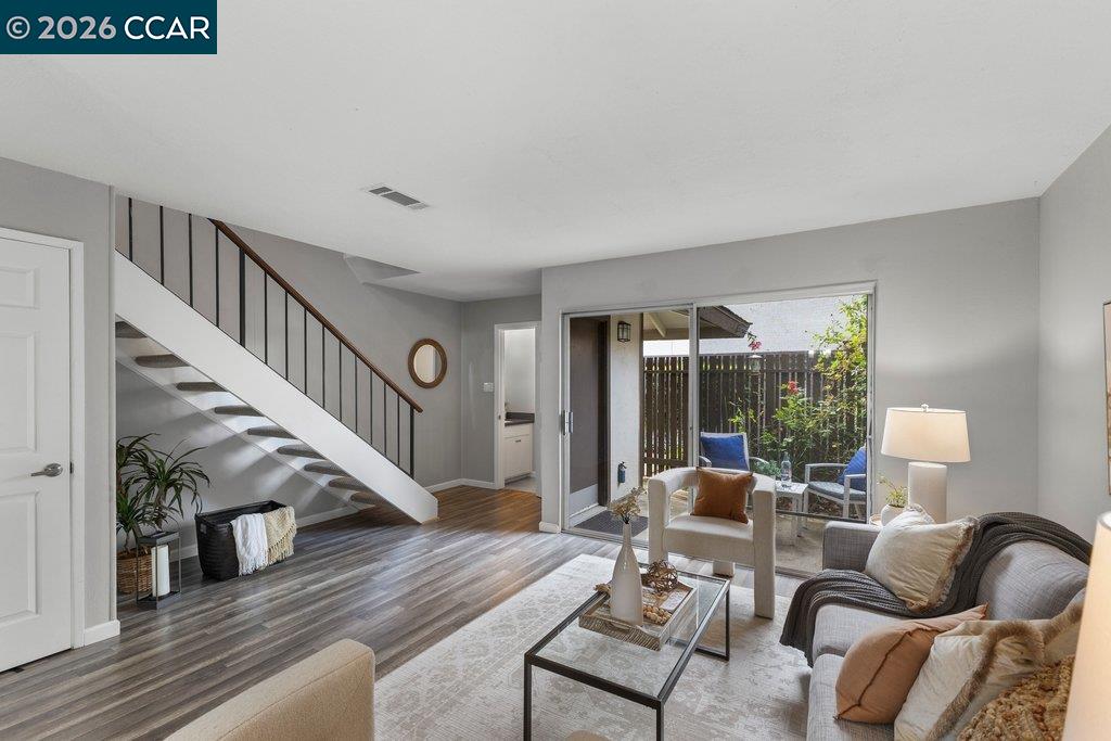 5468 Roundtree Drive, Unit C Concord, CA 94521 - Photo 5 of 27 a living room with furniture and wooden floor
