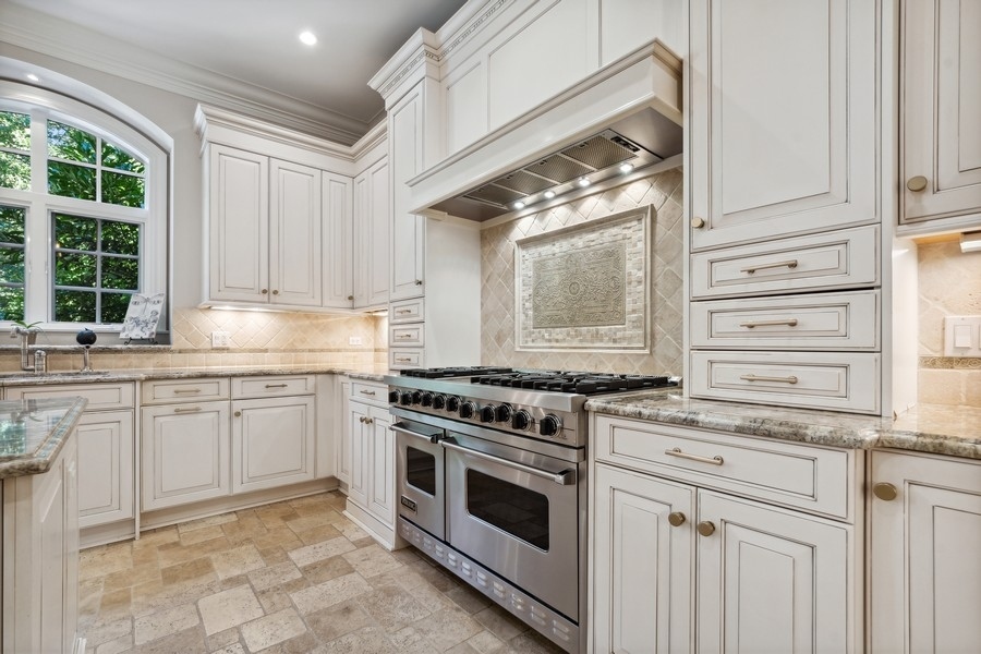 2239 Sheridan Road Highland Park, IL 60035 - Photo 15 of 46 a kitchen with granite countertop stainless steel appliances a stove sink and cabinets