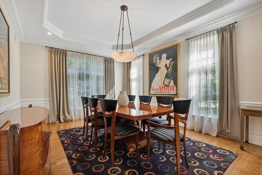 2239 Sheridan Road Highland Park, IL 60035 - Photo 17 of 46 a dining room with furniture a chandelier and wooden floor