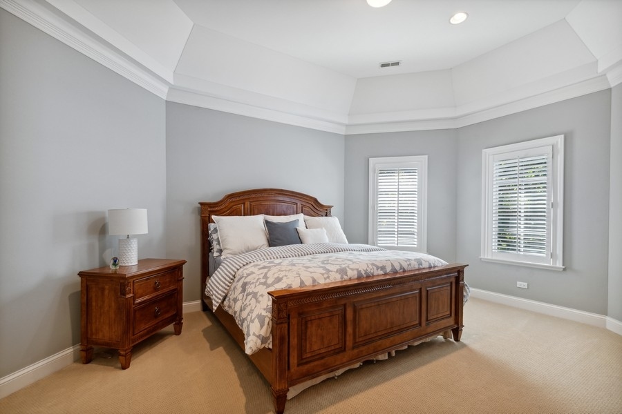 2239 Sheridan Road Highland Park, IL 60035 - Photo 21 of 46 a bedroom with a bed lamp and window