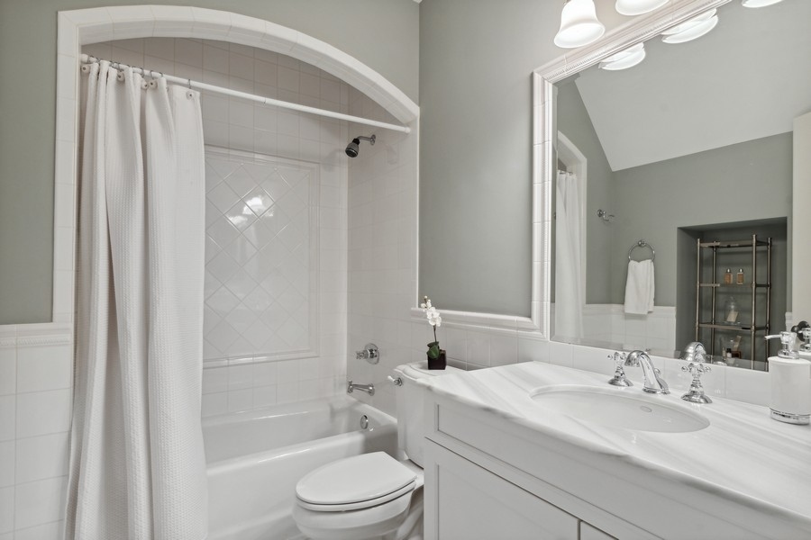 2239 Sheridan Road Highland Park, IL 60035 - Photo 22 of 46 a bathroom with a sink a toilet and shower