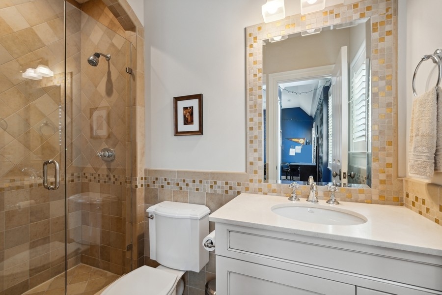 2239 Sheridan Road Highland Park, IL 60035 - Photo 32 of 46 a bathroom with a sink a toilet and shower