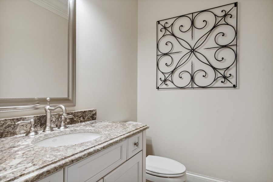 2239 Sheridan Road Highland Park, IL 60035 - Photo 7 of 46 a bathroom with a granite countertop sink and a mirror