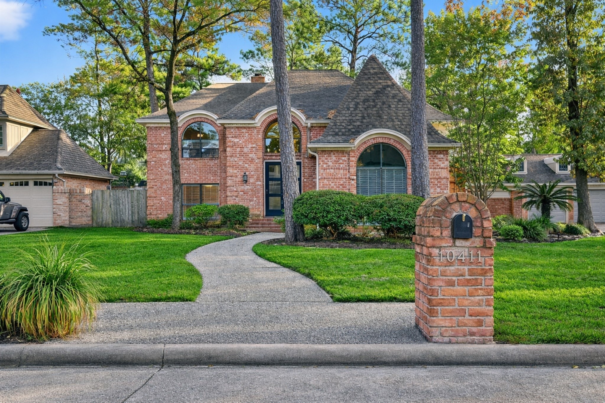 a front view of a house with a garden and plants