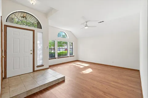an empty room with windows and exposed bricks