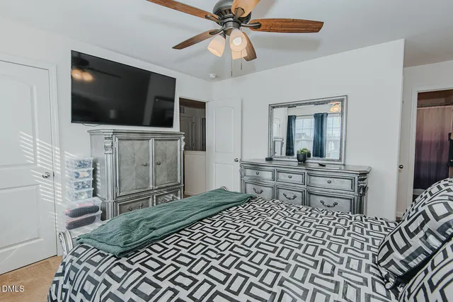 a living room with a flat screen tv and a dresser