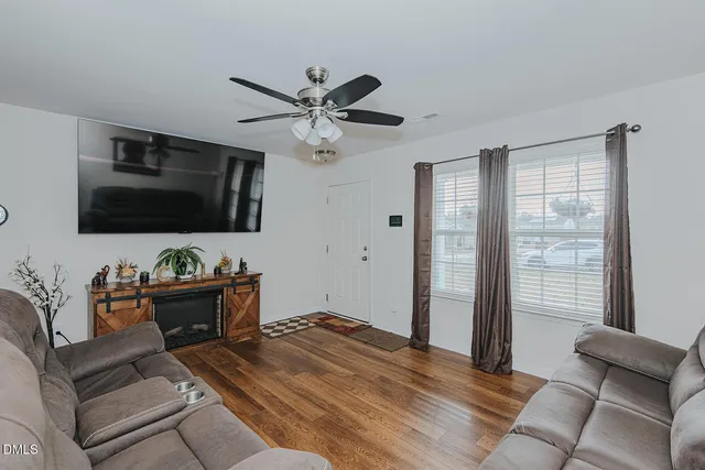 a living room with furniture and a flat screen tv