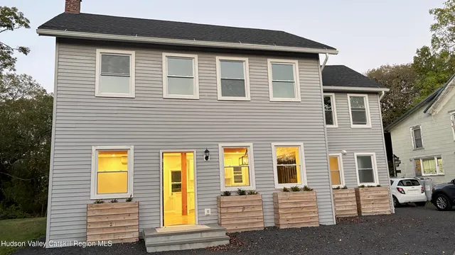 a view of a house with a large window and brick walls