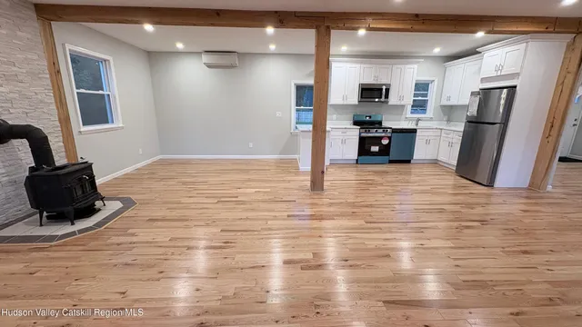 a view of kitchen with refrigerator microwave and stove
