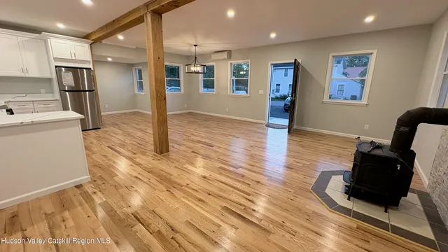 a view of a living room with furniture and wooden floor
