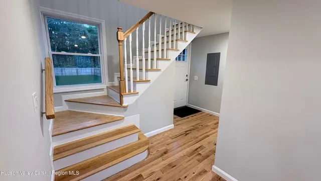 a view of entryway and hall with wooden floor