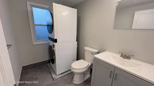 a bathroom with a sink a toilet and a mirror