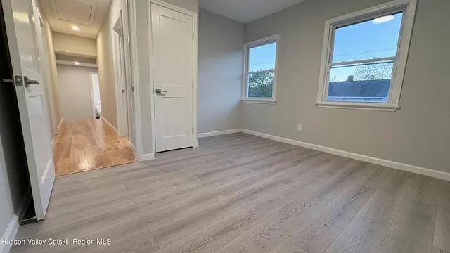 an empty room with wooden floor and a window