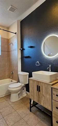 a bathroom with a toilet a sink and bathtub