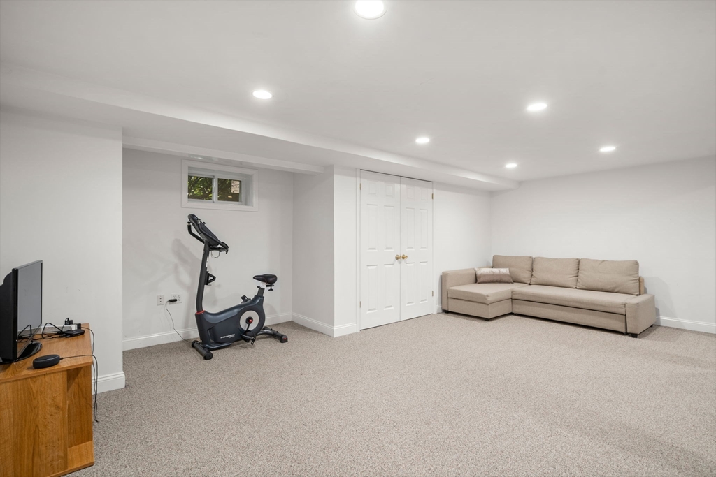 39 Deerfield Road Sharon, MA 02067 - Photo 23 of 31 a living room with furniture and a flat screen tv