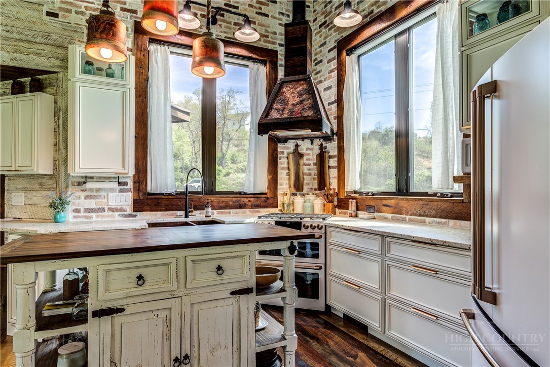 972 West Deep Ford Road Warrensville, NC 28693 - Photo 12 of 36 a kitchen with a sink and a large mirror