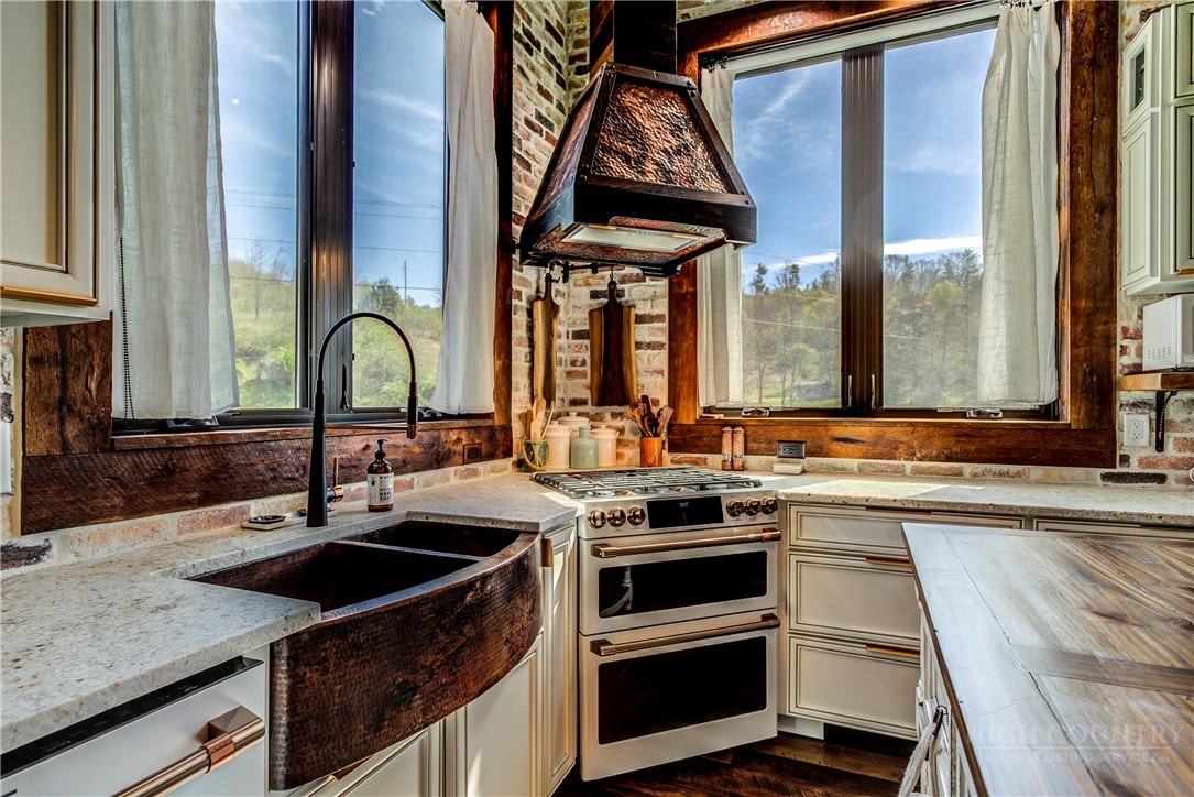 972 West Deep Ford Road Warrensville, NC 28693 - Photo 13 of 36 a kitchen with a sink stove and cabinets