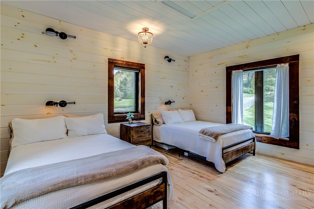 972 West Deep Ford Road Warrensville, NC 28693 - Photo 20 of 36 a bedroom with two beds and a large window