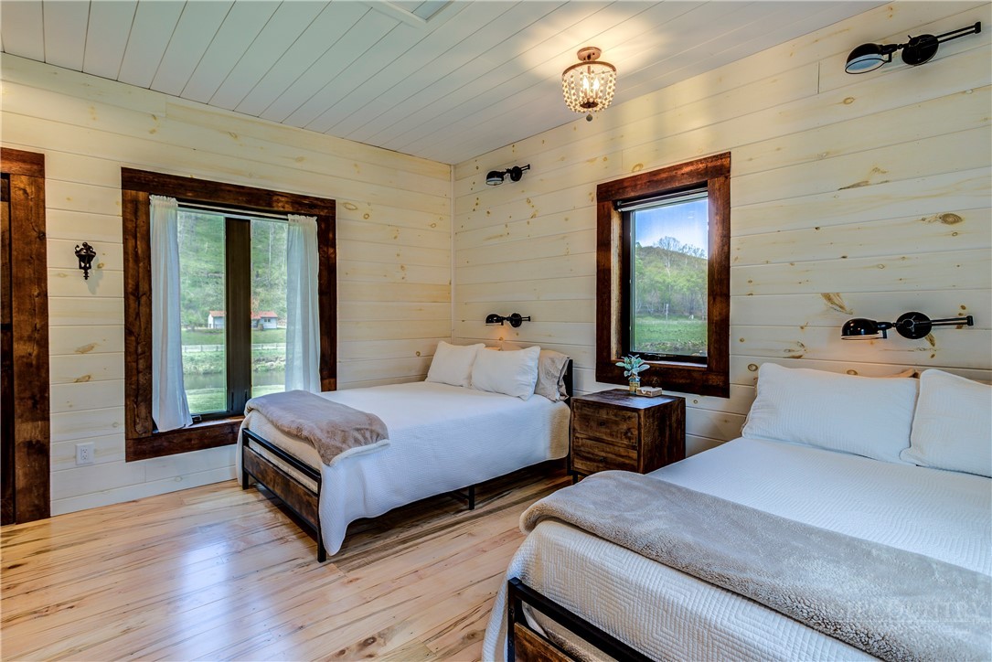 972 West Deep Ford Road Warrensville, NC 28693 - Photo 21 of 36 a bedroom with two beds and a large window