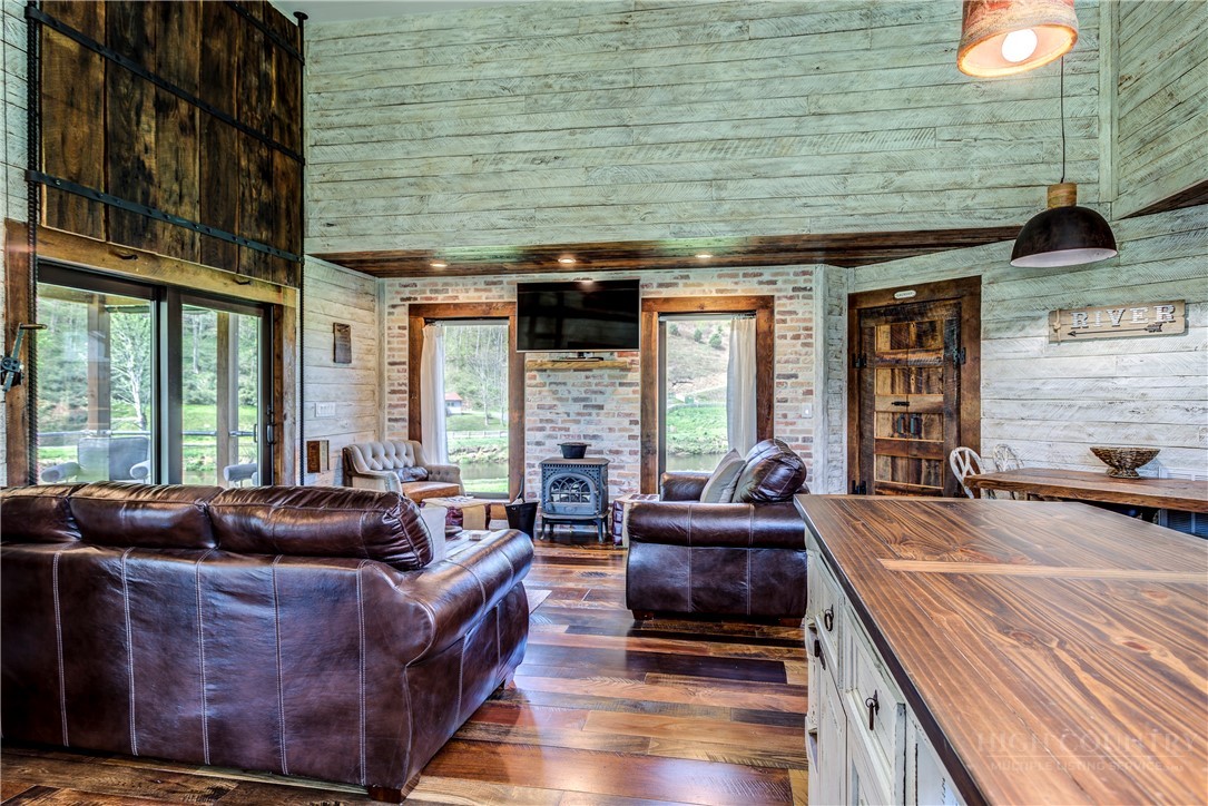 972 West Deep Ford Road Warrensville, NC 28693 - Photo 8 of 36 a living room with furniture and large windows