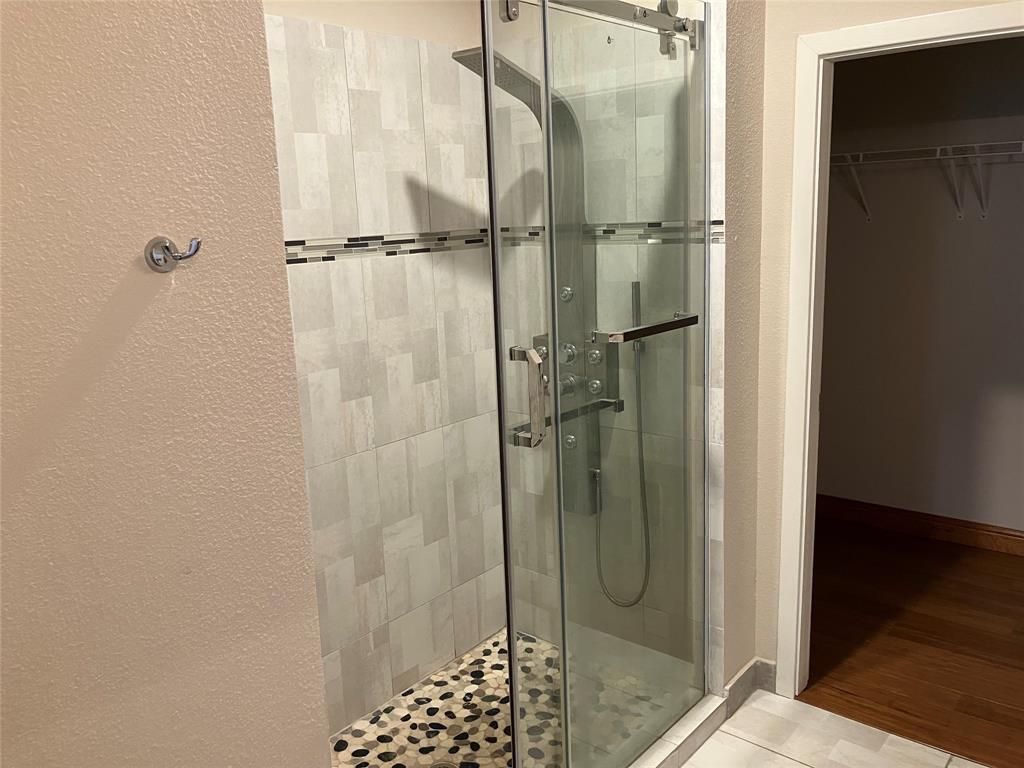 1220 West Trinity Mills Road, Unit 5009 Carrollton, TX 75006 - Photo 9 of 25 a bathroom with a glass shower door