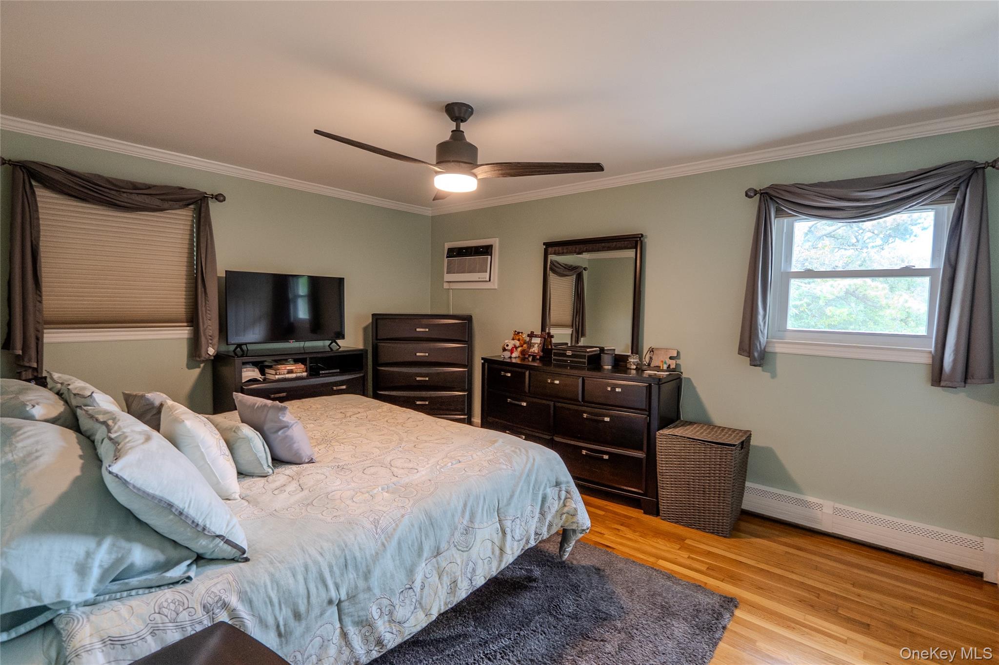 45 Harvard Lane Commack, NY 11725 - Photo 11 of 19 a bedroom with a bed and a flat screen tv