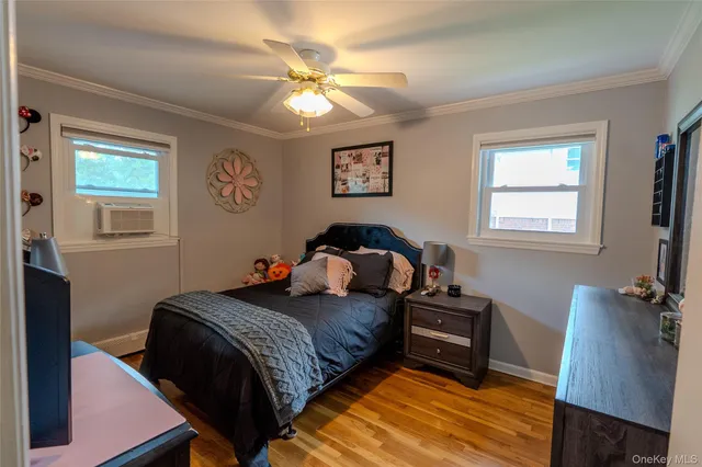 a bedroom with a bed and a lamp on dresser