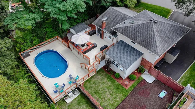 an aerial view of a house with garden space and street view