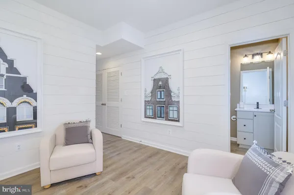 a living room with furniture a flat screen tv and wooden floor