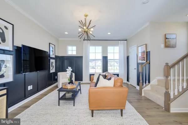 a living room with furniture a chandelier and a dining table
