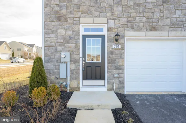 a view of a hallway with wooden floor and a window