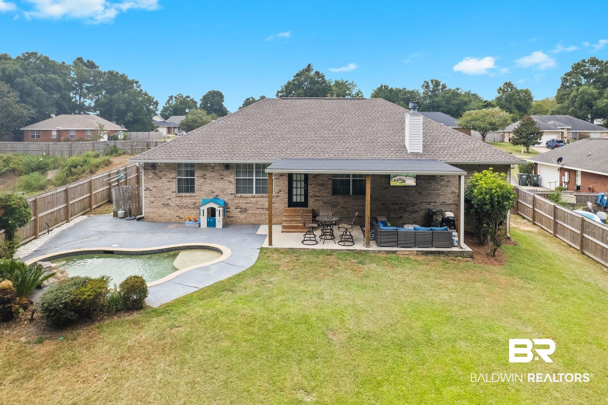28246 Turkey Branch Drive Daphne, AL 36526 - Photo 27 of 41 Back of property featuring a fenced in pool, a patio, a yard, and an outdoor living space