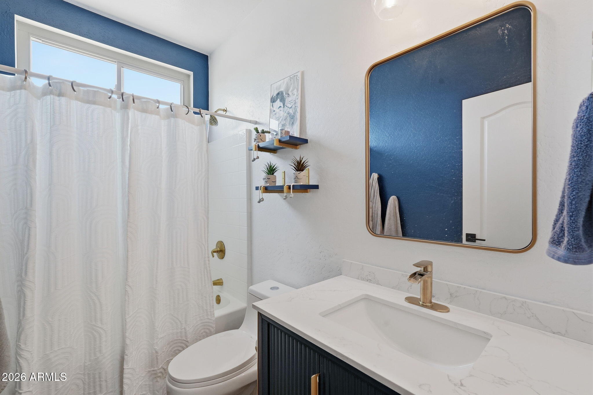 4184 East Trigger Way Gilbert, AZ 85297 - Photo 26 of 51 a bathroom with a sink a toilet and shower curtain
