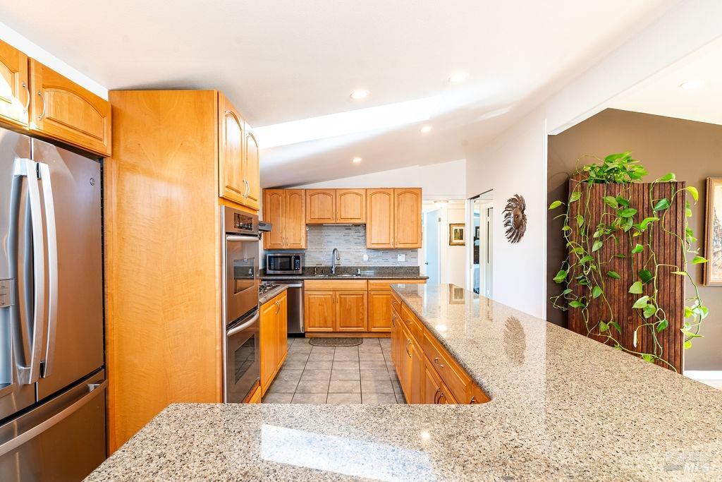 1108 Ferris Drive Novato, CA 94945 - Photo 7 of 24 a large kitchen with stainless steel appliances granite countertop a refrigerator a oven and a sink