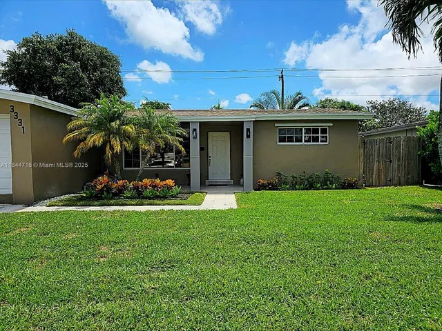 a front view of house with yard and outdoor seating