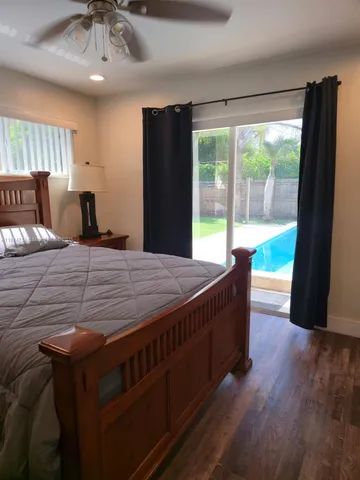 a living room with large window and a wooden floor