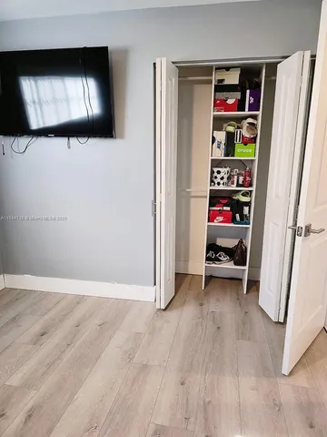 a view of a livingroom with wooden floor and closet