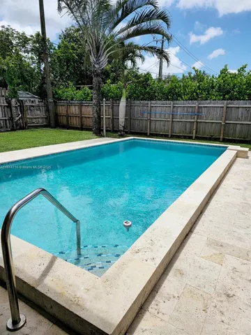 a view of a backyard with a swimming pool